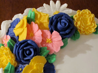 A close up of a flowers on top of a cake