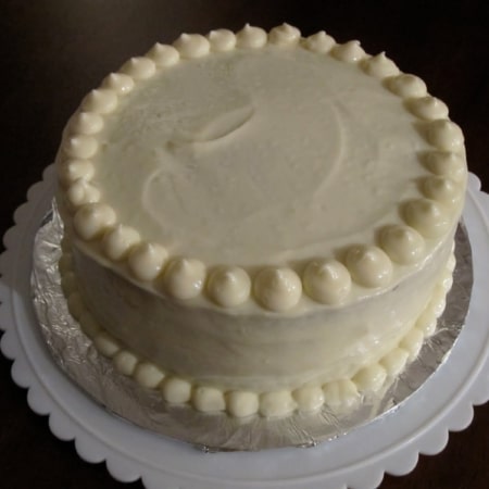 White frosted cake on a table.