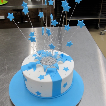 A blue and white cake on a table