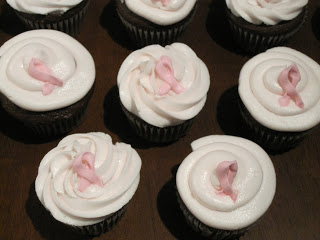 Pink buttercream on chocolate cupcakes.