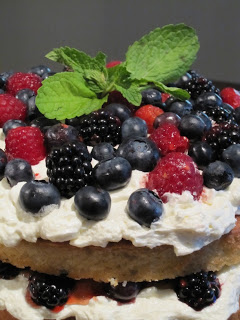 A close up of fruit on top of a cake.