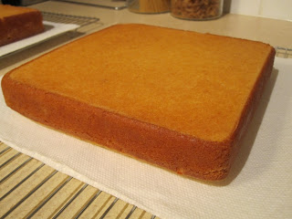 Square cake on a cooling rack.