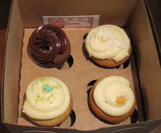 A box filled with different kinds of cupcakes