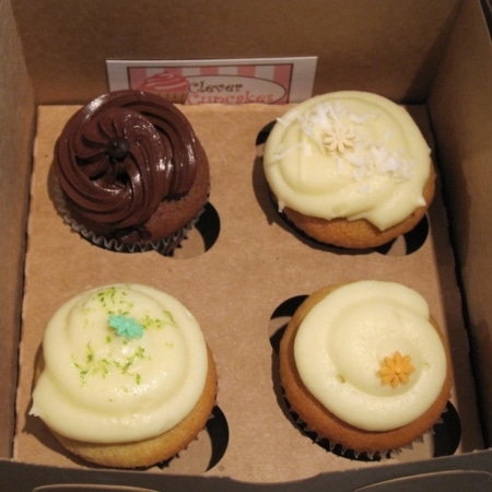A box filled with different types of cupcakes