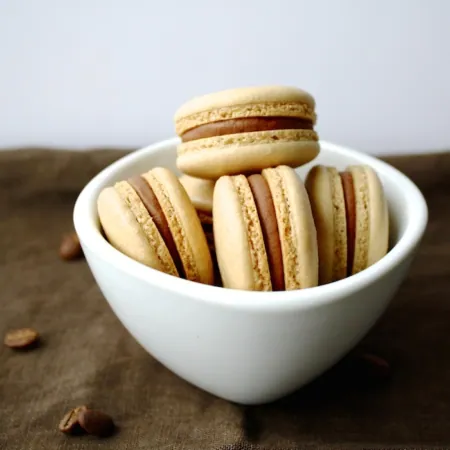 Macarons in a white bowl.
