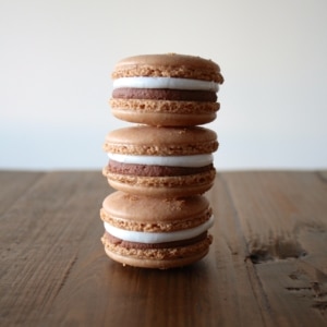 Stack of macarons on a wooden table.