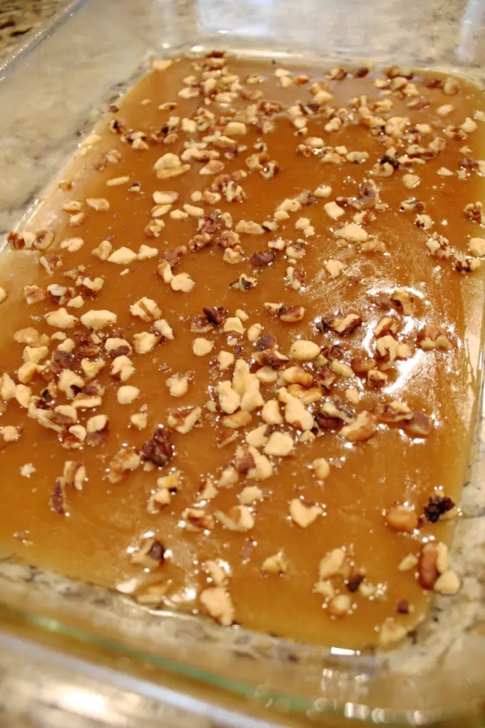 Caramel and nuts in baking dish.