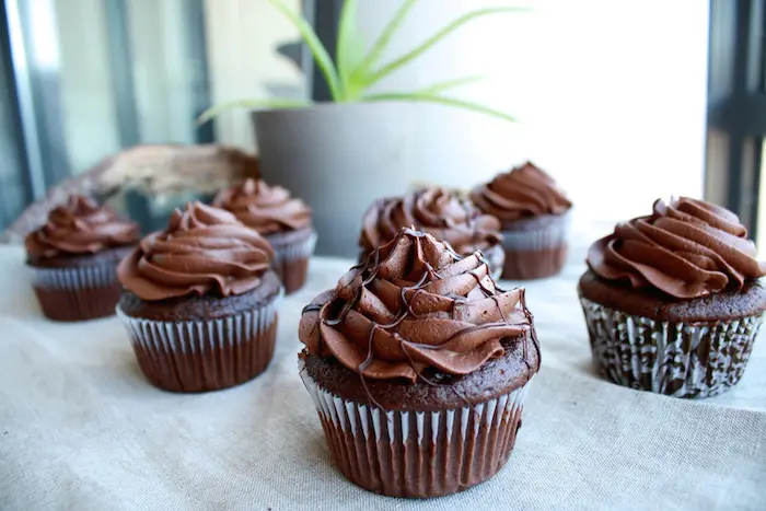 Chocolate cupcakes on a table.