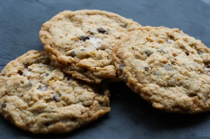 Three cookies on a dark background.