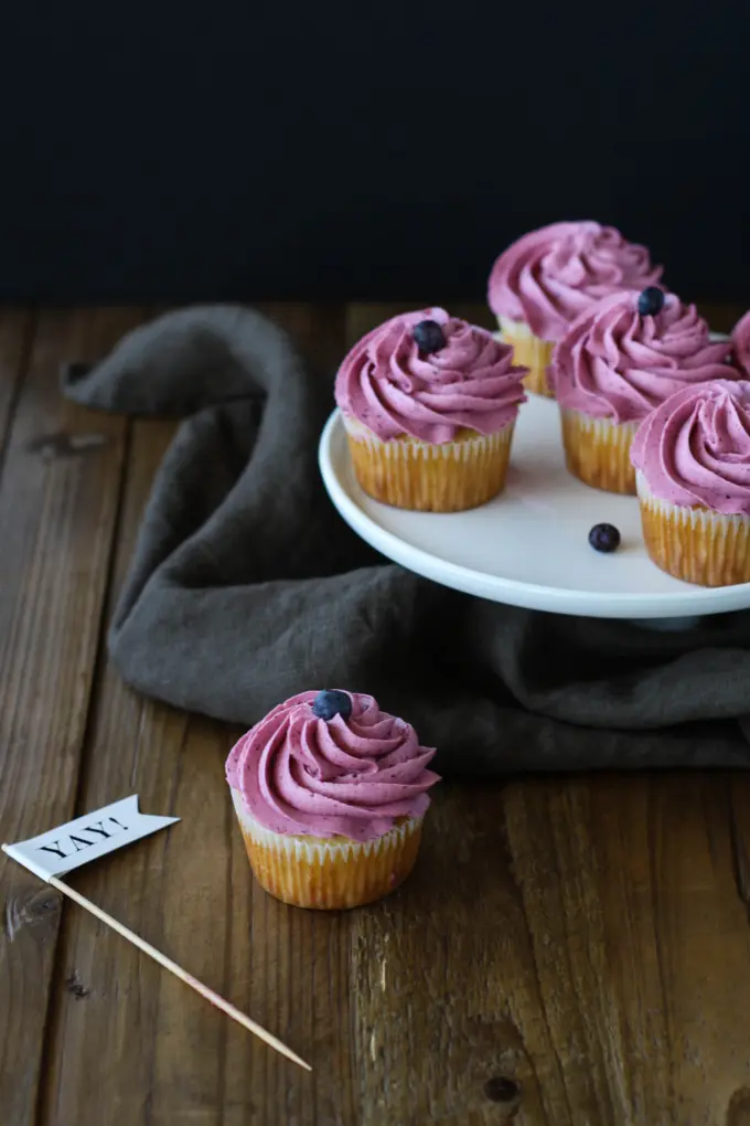 Cupcakes on top of a wooden table.