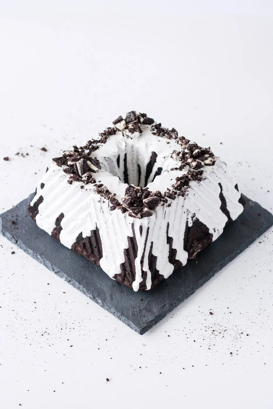 Square bundt cake on a slate plate on a white background.