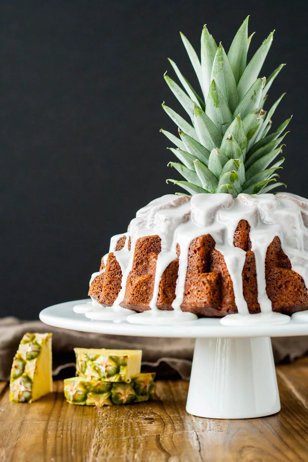 Tropical bundt cake on a white cake stand.