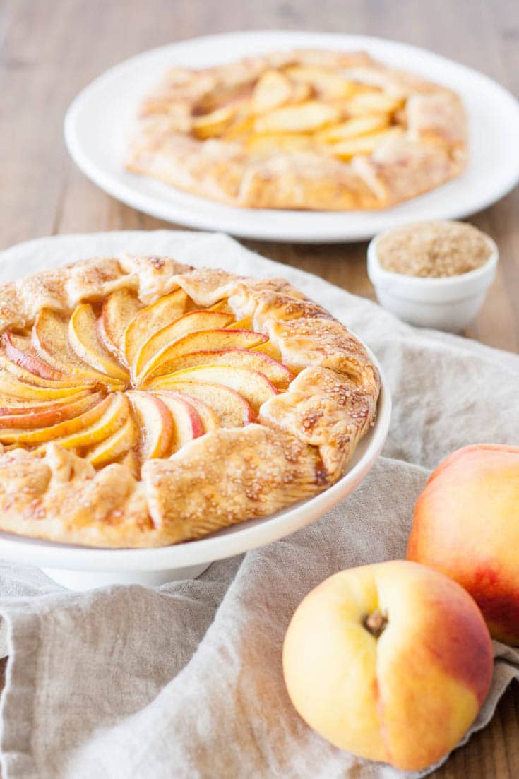 Angled shot of the galette with peaches next to it.