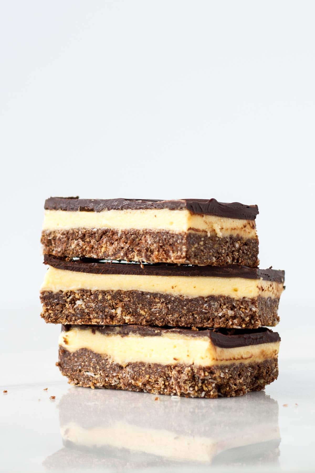 Three Nanaimo bars stacked on each other.