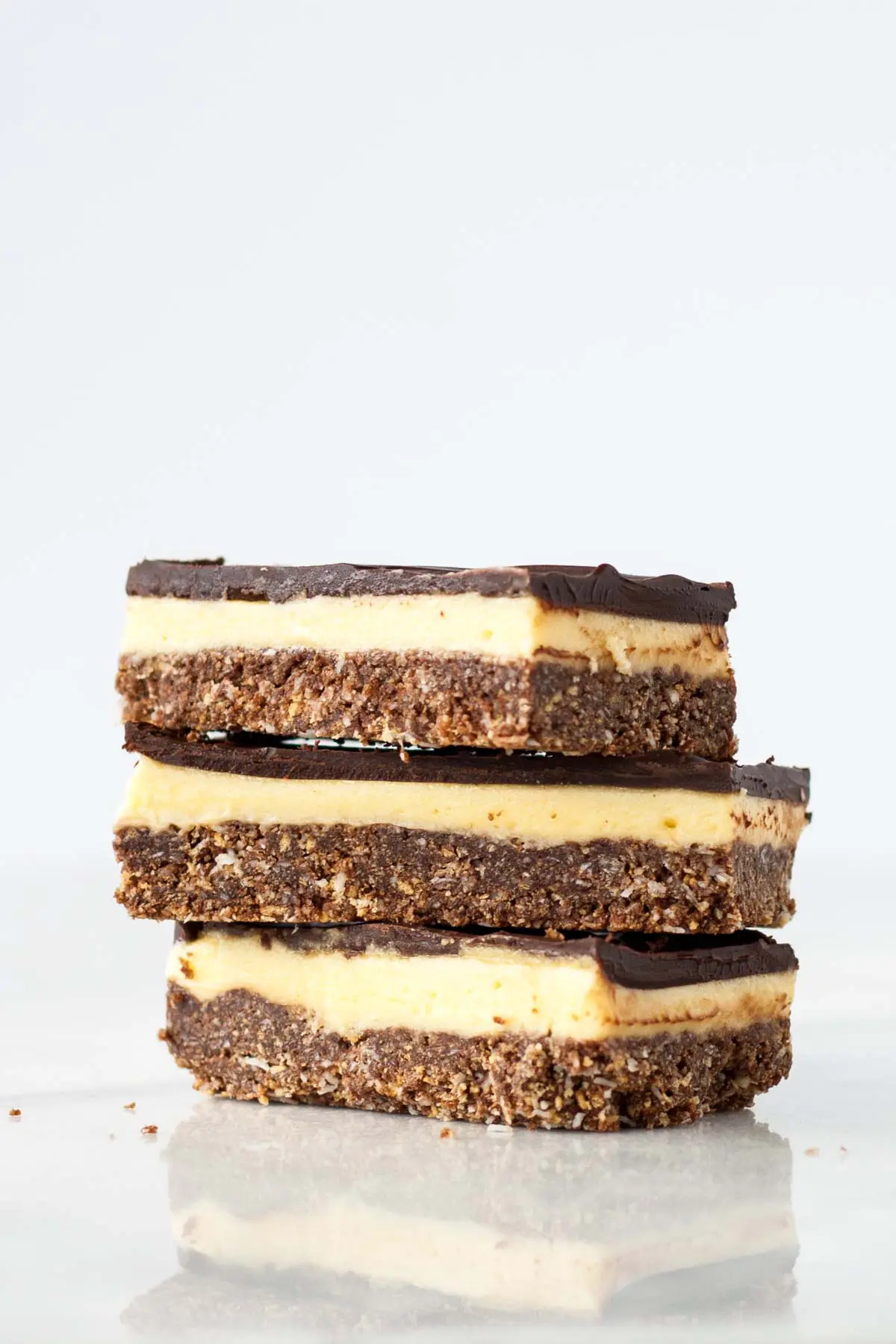 Three Nanaimo bars stacked on each other.