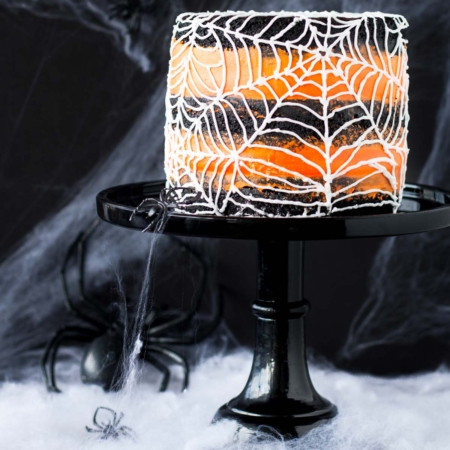 This spiderweb cake is perfect for Halloween! A rich black cocoa cake with an orange flavoured buttercream. | livforcake.com