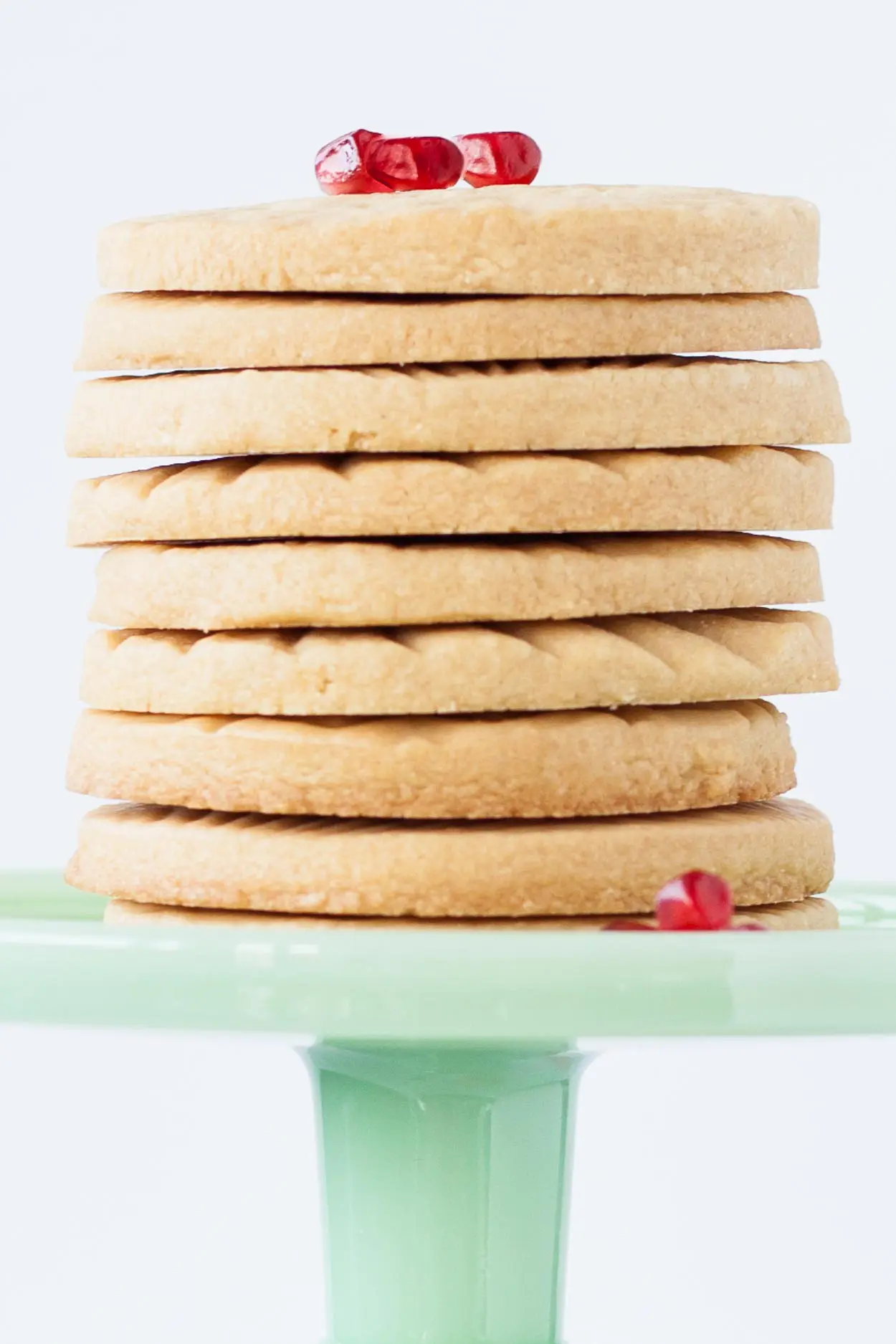 Stack of cookies on a green cake stand.