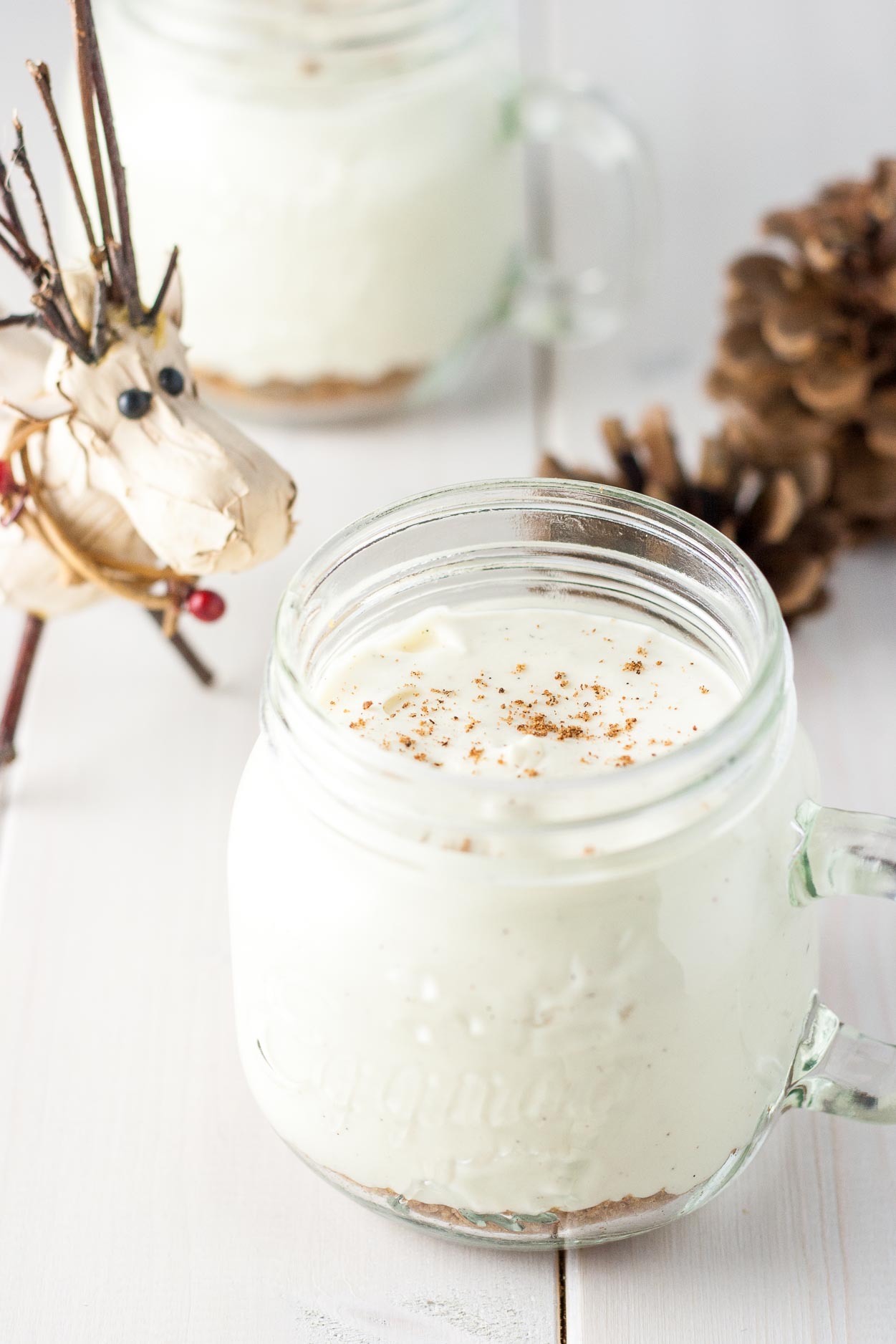 Eggnog mousse with holiday decor around it.