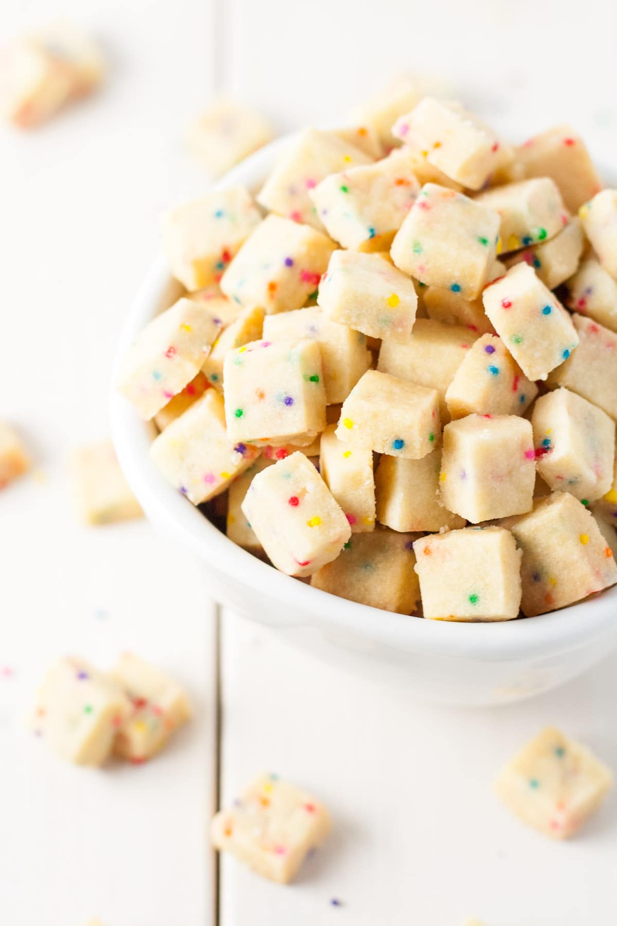 Teeny tiny shortbread cookies studded with rainbow sprinkles. So addictive, the kids will love these! A simple change in the color of the sprinkles and you're set for any holiday or event. | livforcake.com