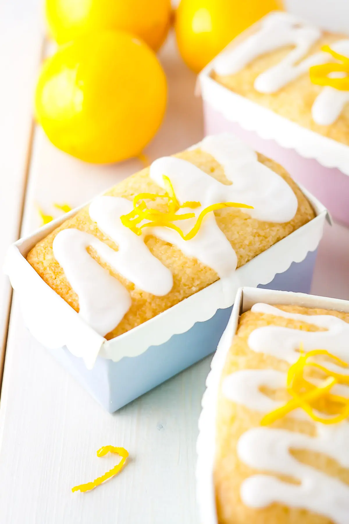 Three mini lemon loaves in pastel liners.