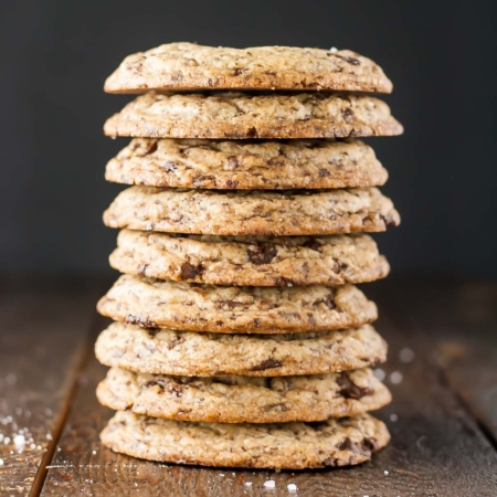 A stack of cookies on a wooden table.