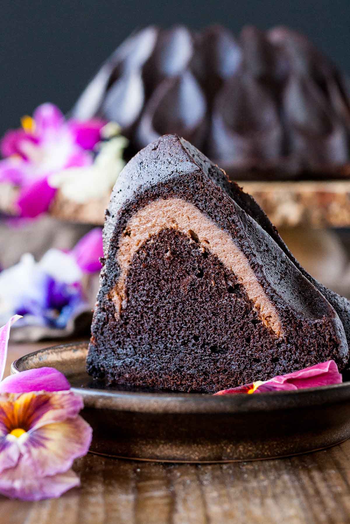 Slice of cheesecake stuffed bundt cake on a plate.