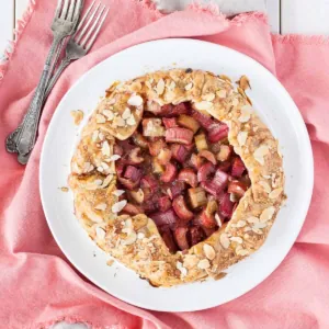 Overhead shot of the rhubarb galette on a white plate on a pink napkin.