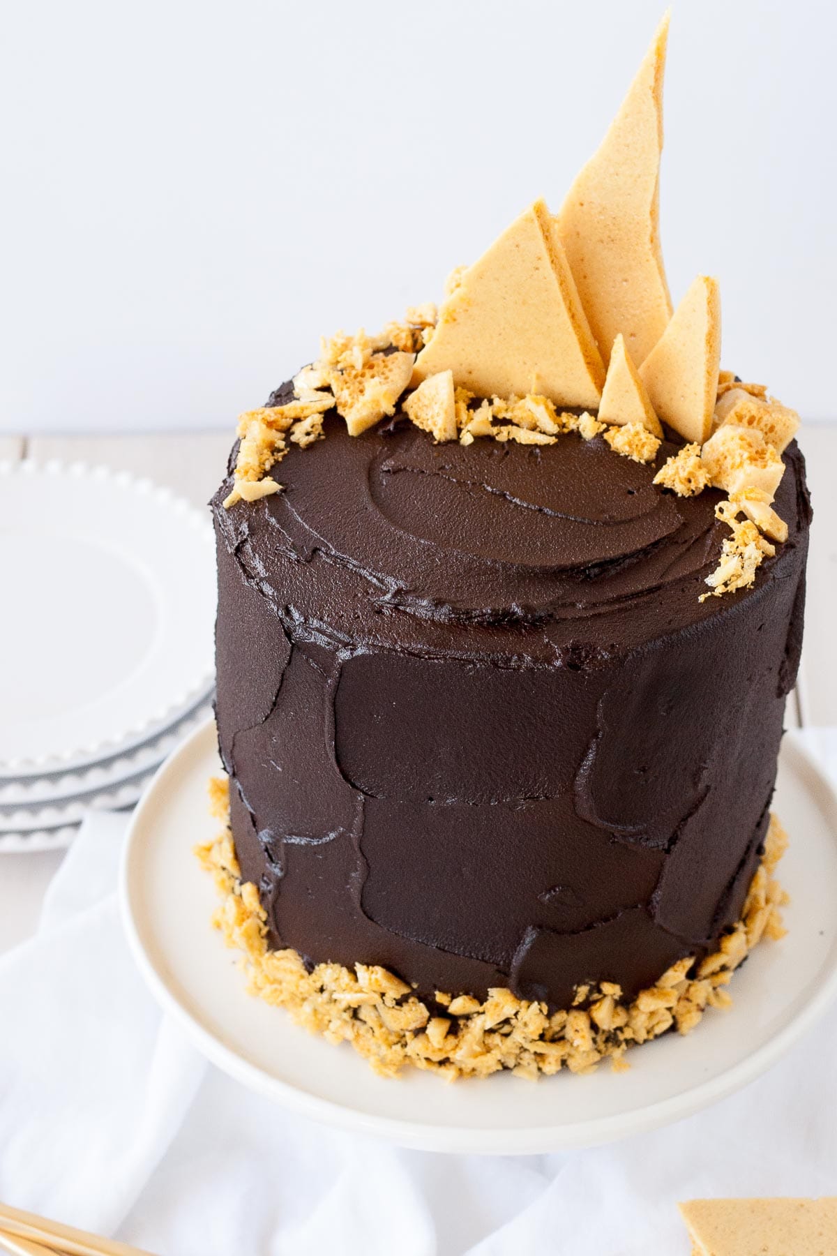 Chocolate cake with honeycomb shards on the top.