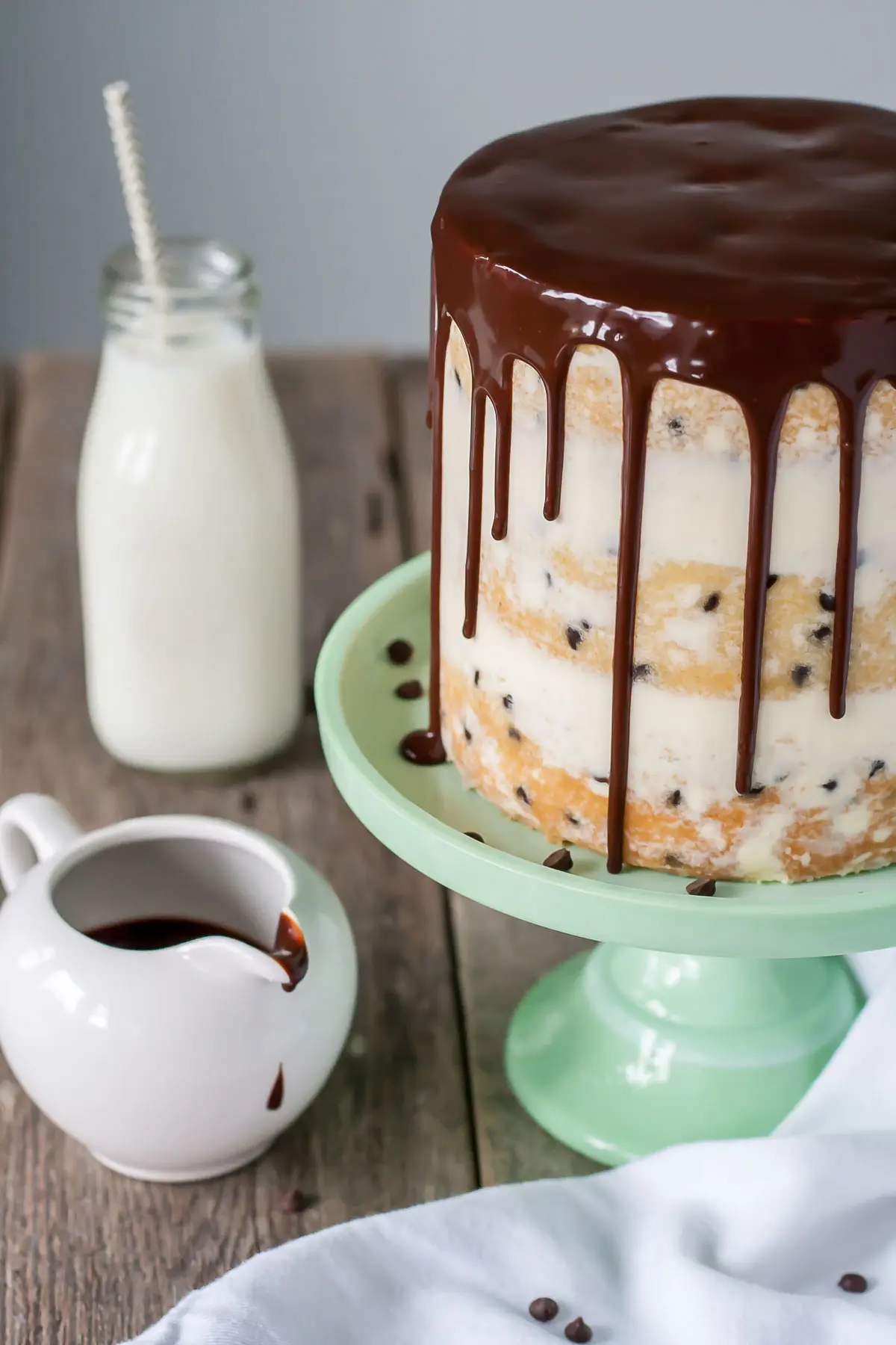 Angled shot of the cake with a glass of milk in the background.