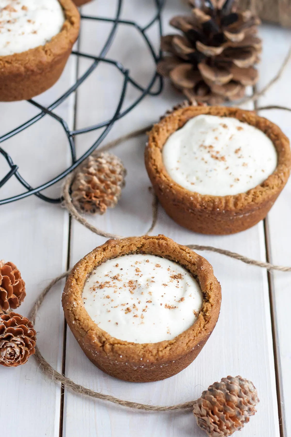 cookie cups with festive decor beside them