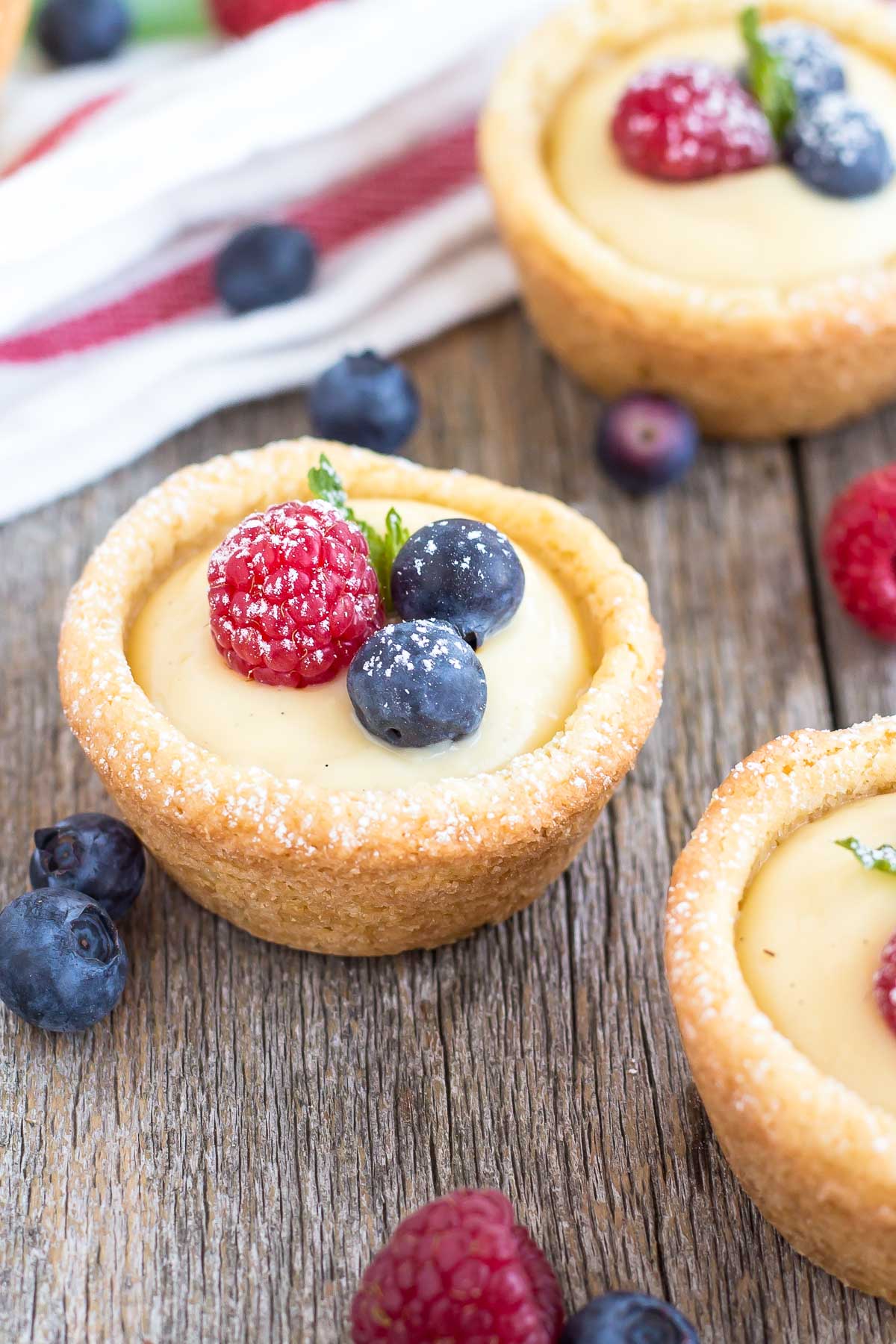 A cookie cup with fruit on top of a wooden table.