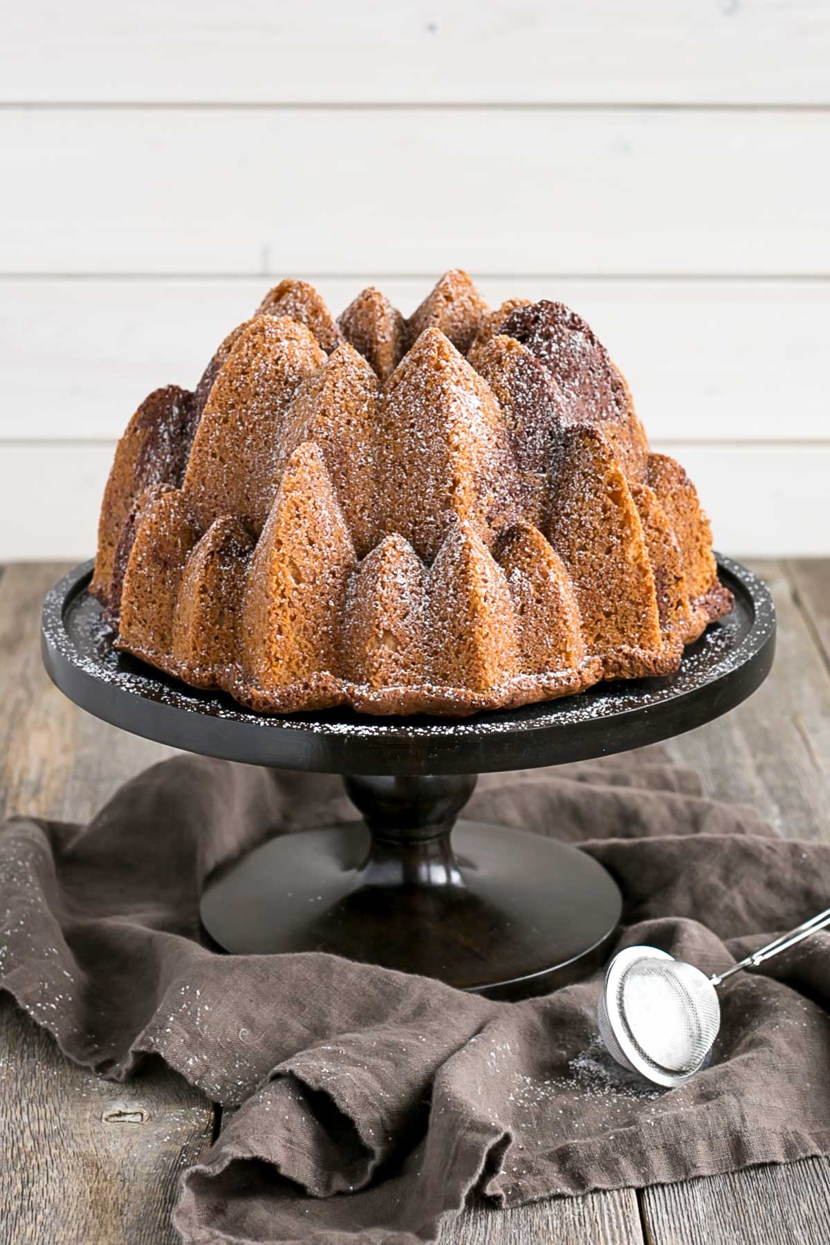 Bundt cake on a dark cake stand.