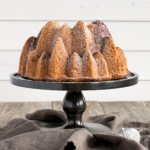 Bundt cake on a wooden cake stand.