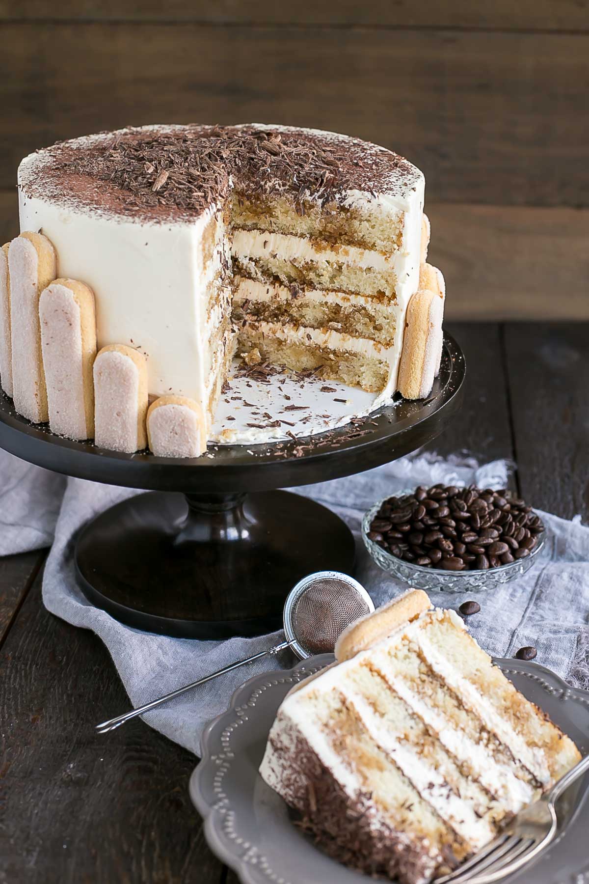 This Tiramisu Cake turns your favourite Italian dessert into a delicious and decadent layer cake. Coffee soaked layers paired with mascarpone buttercream. | livforcake.com