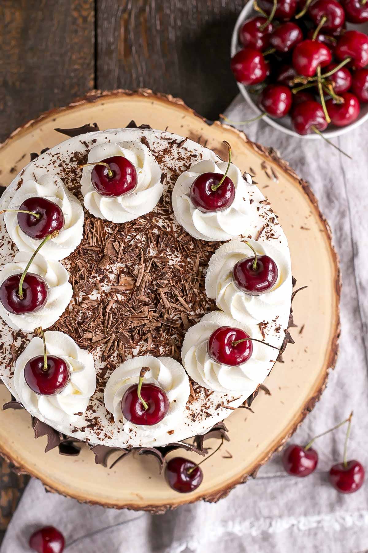 This Black Forest Cake combines rich chocolate cake layers with fresh cherries, cherry liqueur, and a simple whipped cream frosting. | livforcake.com