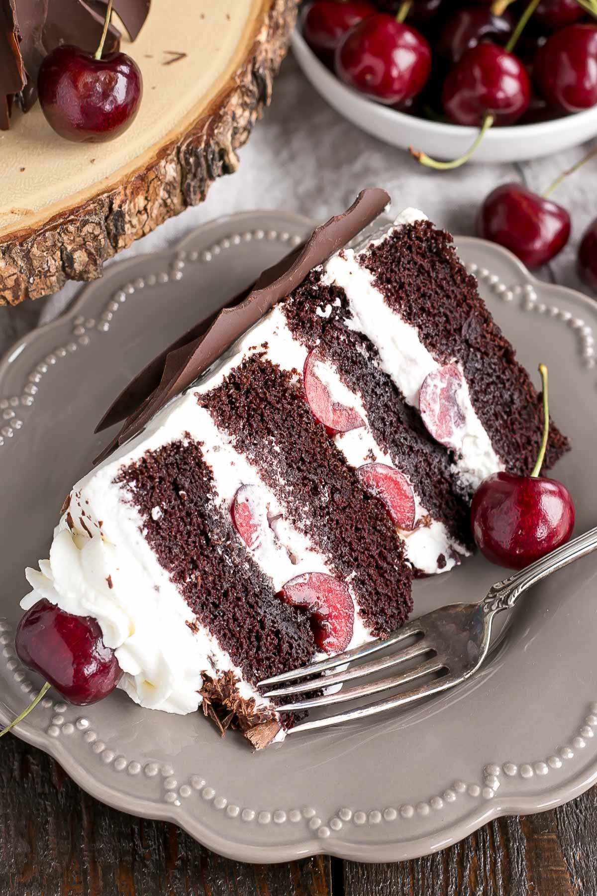 This Black Forest Cake combines rich chocolate cake layers with fresh cherries, cherry liqueur, and a simple whipped cream frosting. | livforcake.com