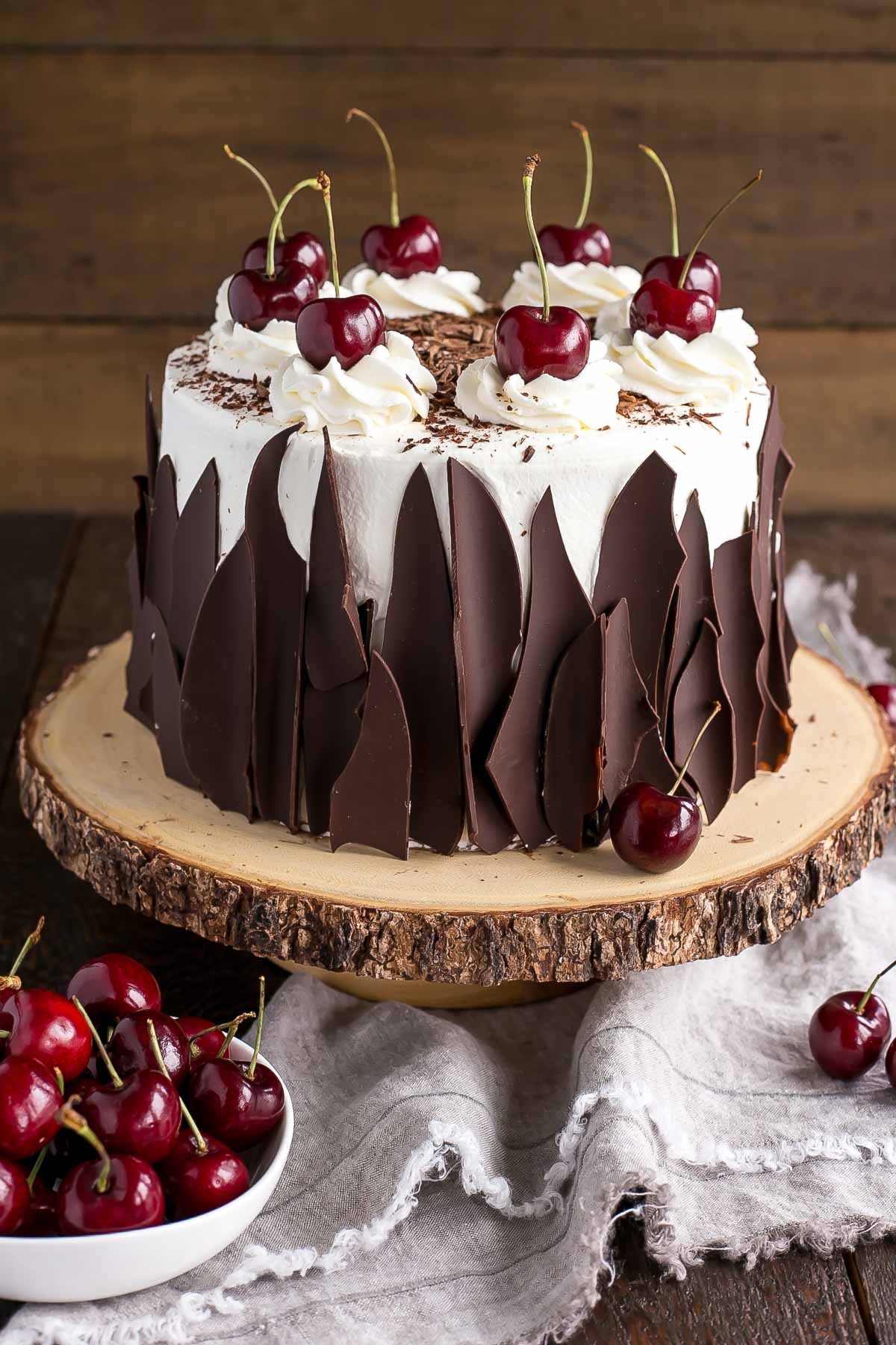 Cake with fresh cherries beside it.