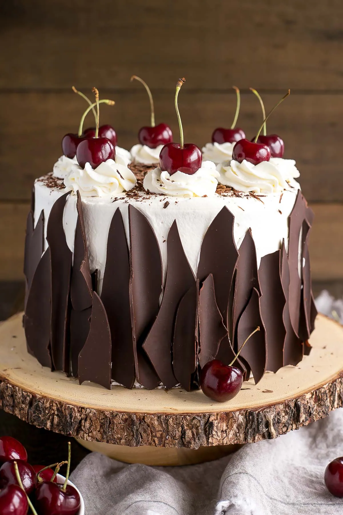 This Black Forest Cake combines rich chocolate cake layers with fresh cherries, cherry liqueur, and a simple whipped cream frosting. | livforcake.com