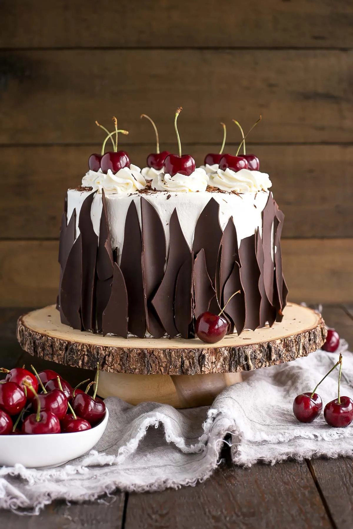 This Black Forest Cake combines rich chocolate cake layers with fresh cherries, cherry liqueur, and a simple whipped cream frosting. | livforcake.com