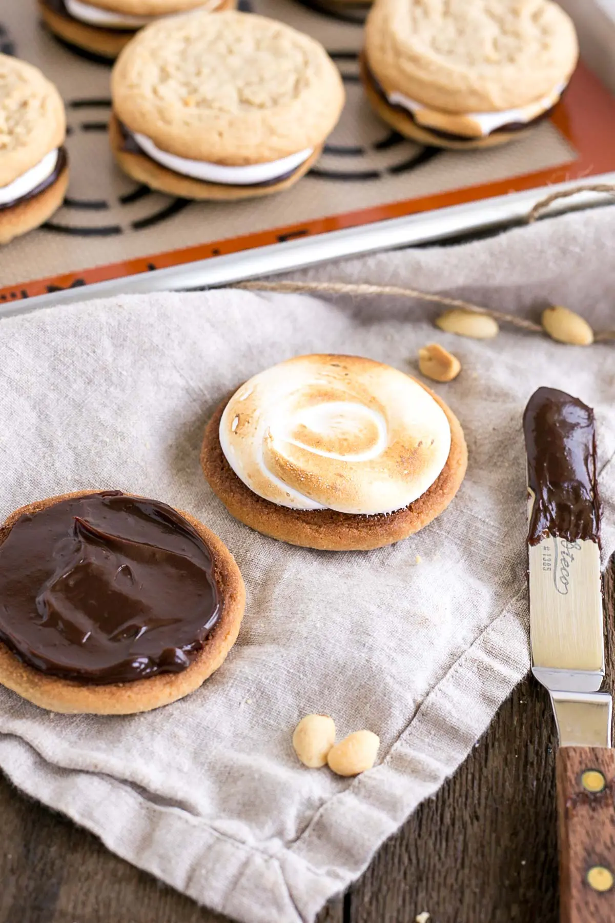 Two cookies shown, one with ganache and one with toasted marshmallow.