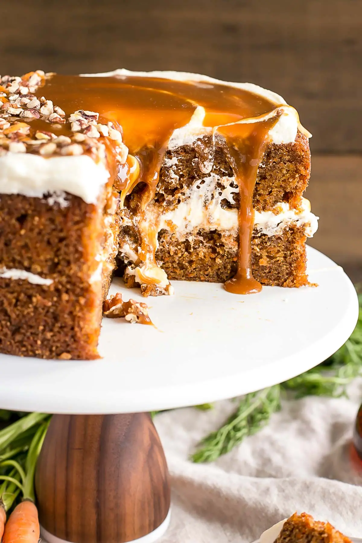 Cross-section of the maple caramel carrot cake showing gooey caramel dripping down.