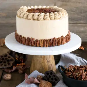 This Pecan Pie Cake is perfect for your holiday get-togethers! Brown sugar cake layers and buttercream filled with traditional pecan pie filling. | livforcake.com