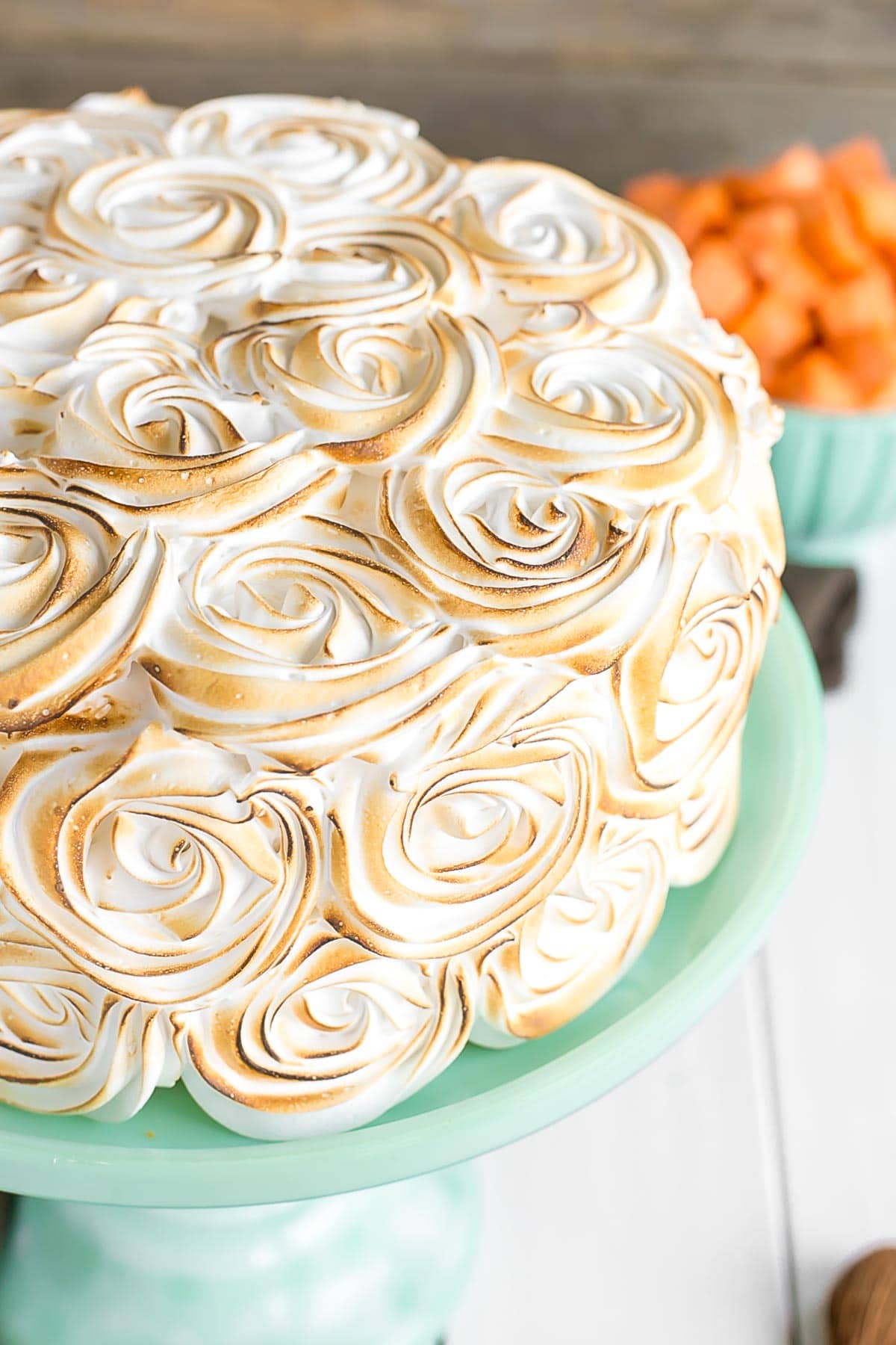 Close up of the toasted frosting swirls on the cake.