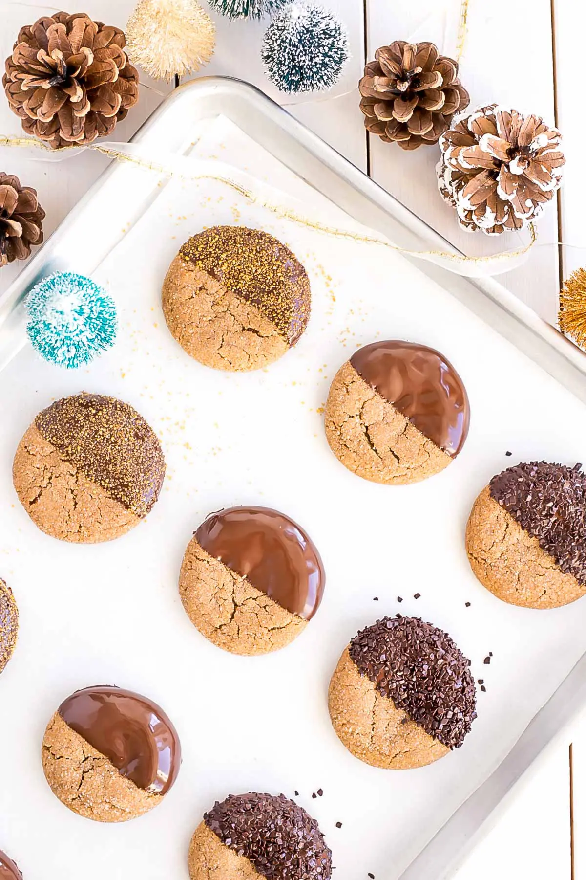 Variety of chocolate dipped cookies on a baking sheet.