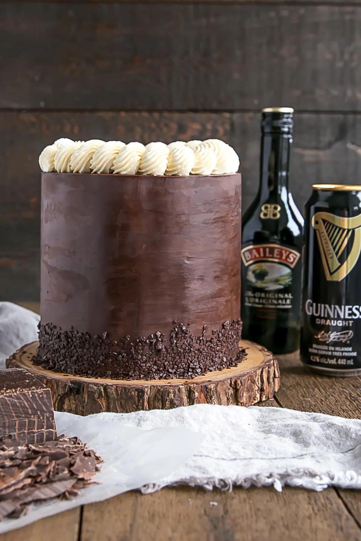Baileys & Guinness Cake on a wooden cake stand.