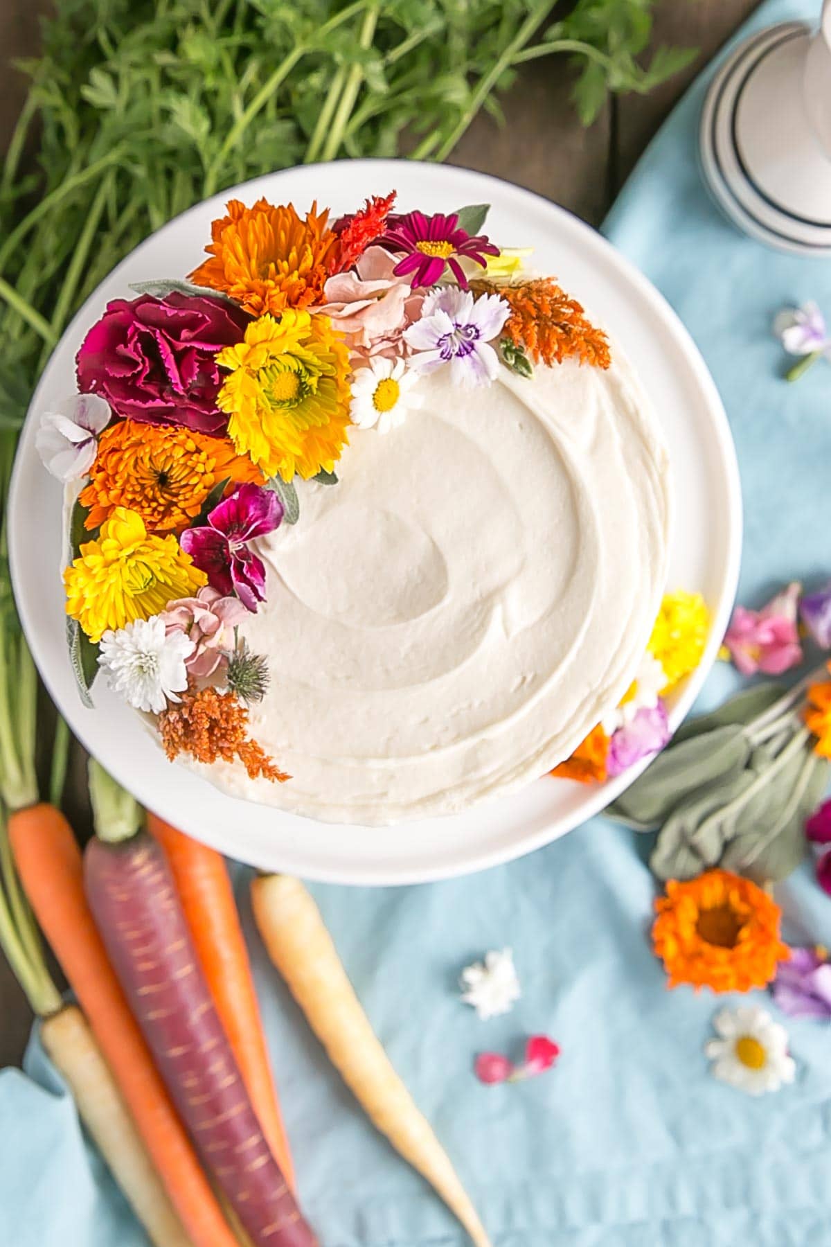 Top down picture of carrot cake with edible flowers.