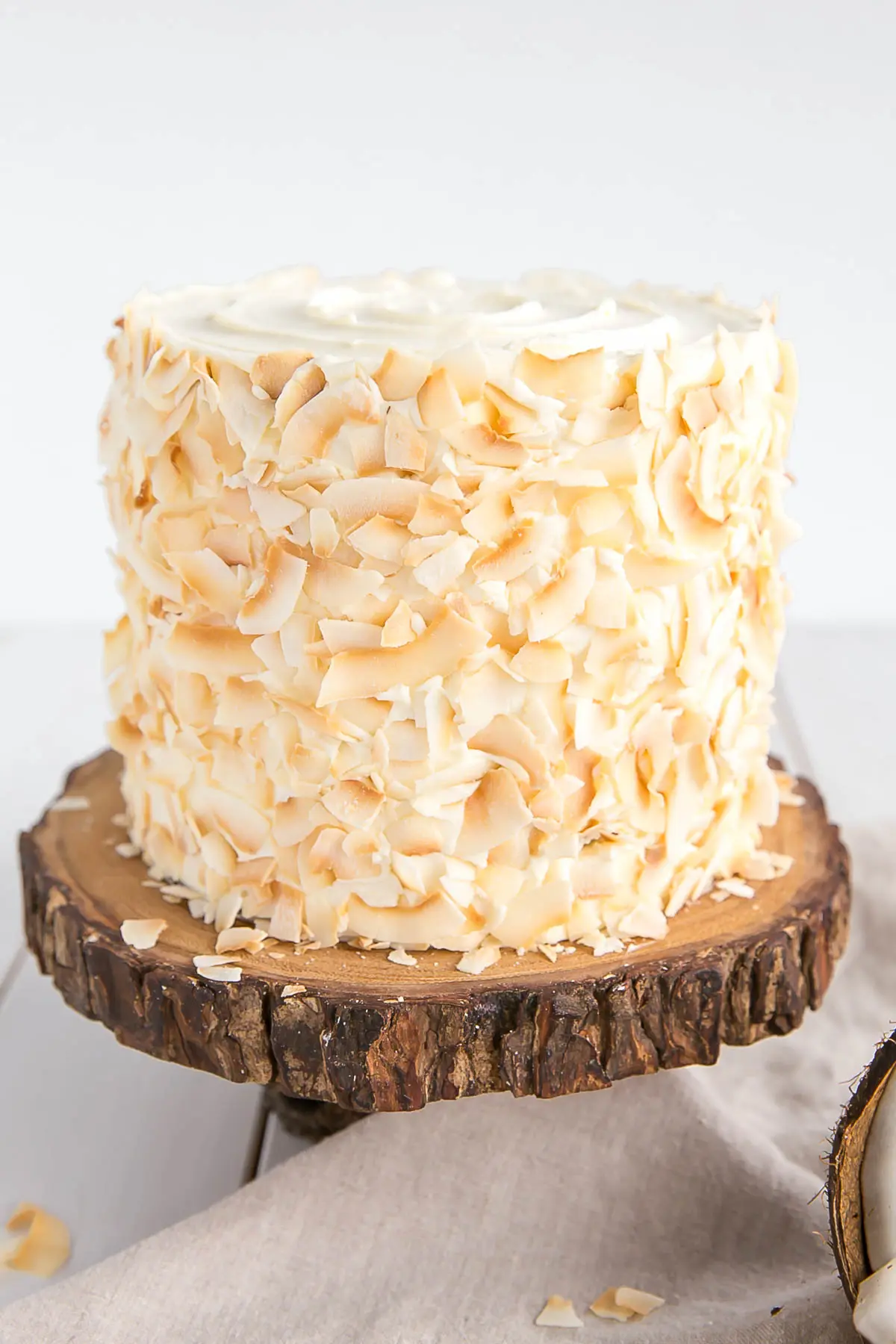 Toasted coconut flakes decorate the outside of the cake.