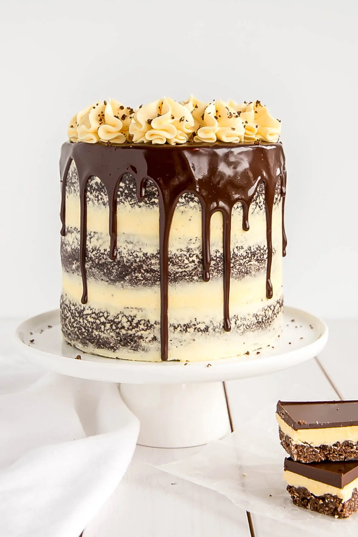 Nanaimo Bar cake on a cake stand.