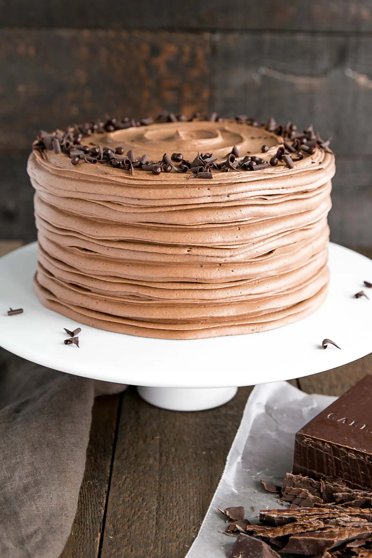 Coup de gâteau incliné du gâteau sur un support de gâteau blanc.