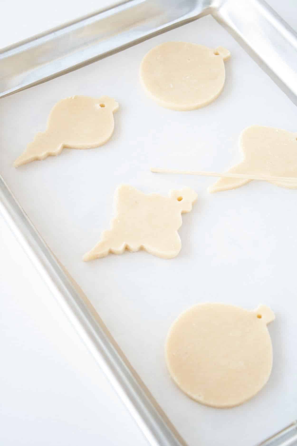 Cut out cookies on a baking sheet
